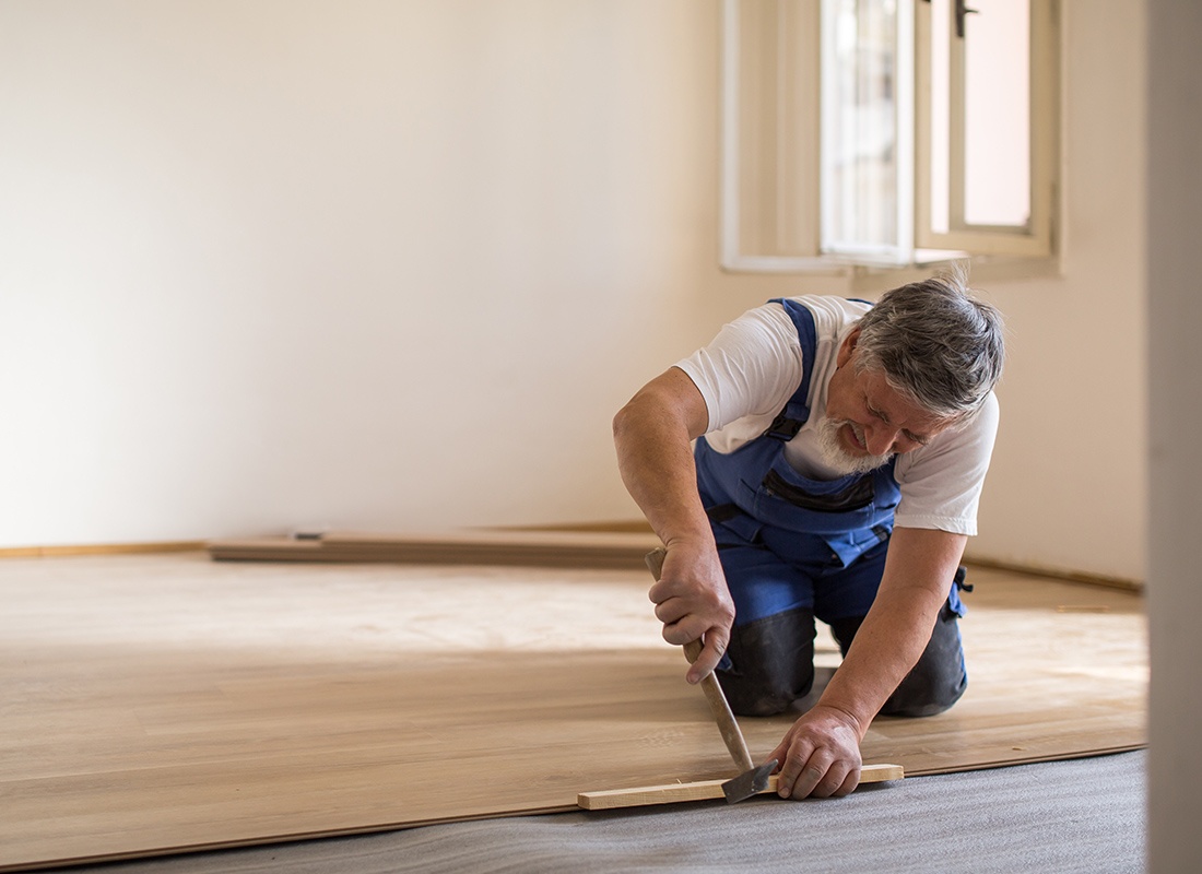 Insurance by Industry - Floor contractor installing wood flooring