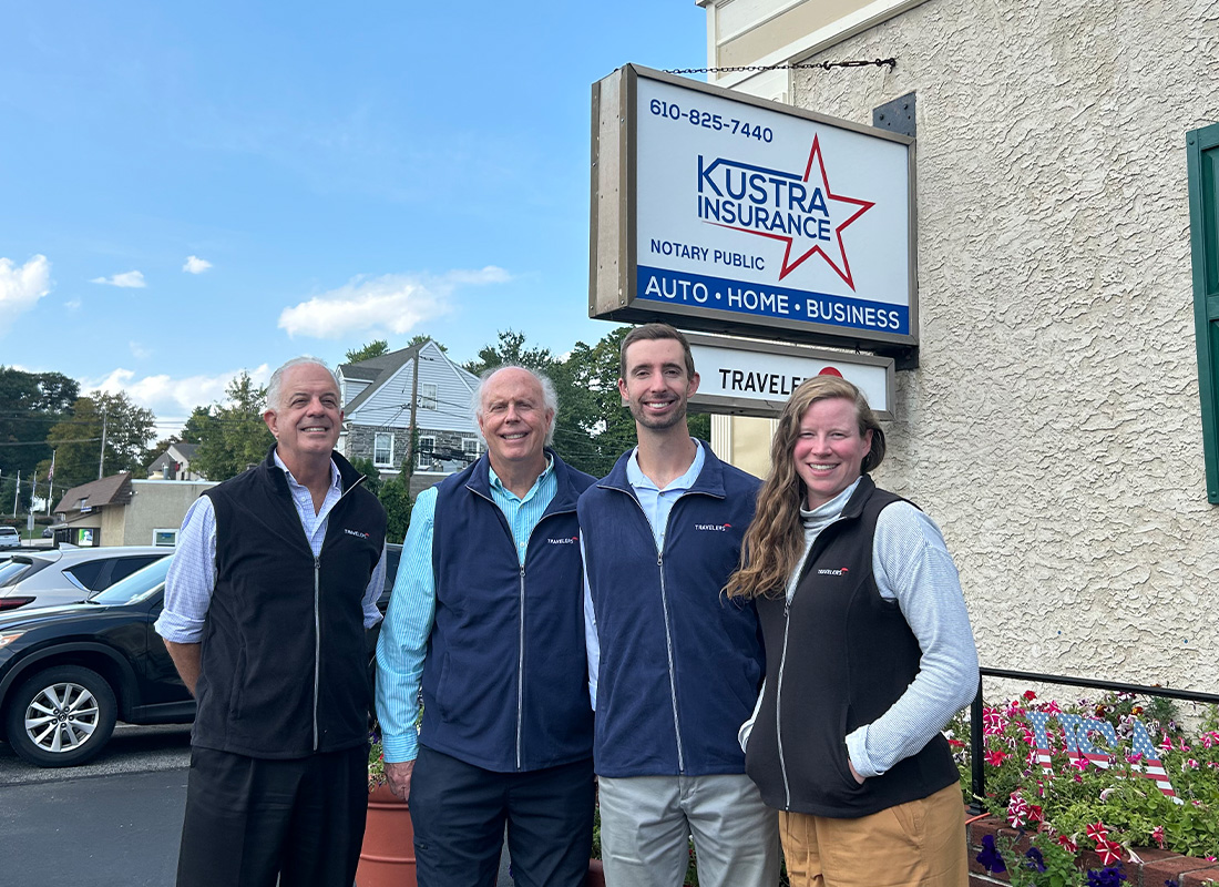 About - Kustra Insurance Team Outside the Office, in Front of the Kustra Insurance Sign